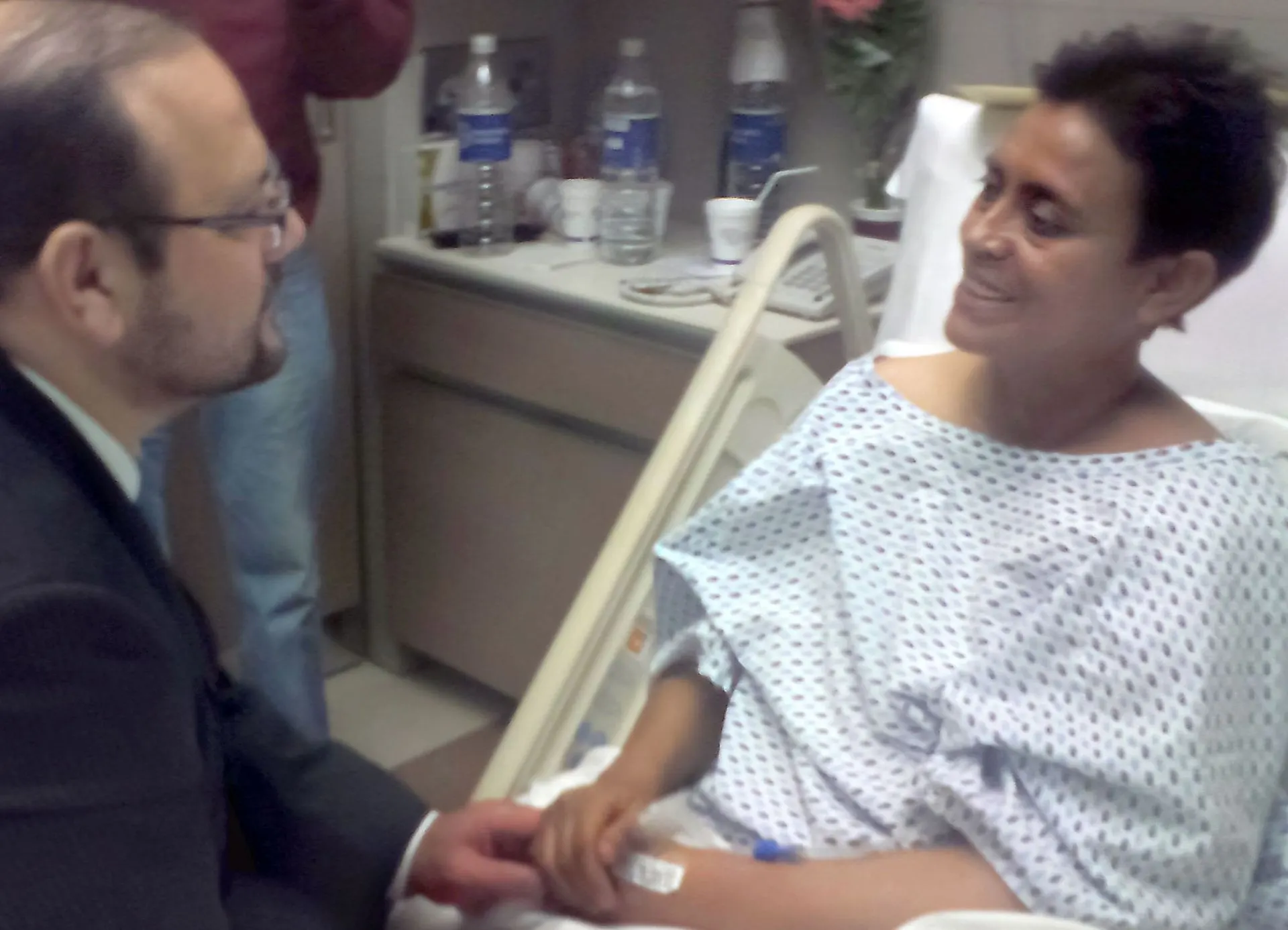 Dr. Frank Arguello acompañando a una paciente en el hospital